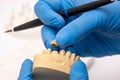 Dental technician using a brush with ceramic dental implants in his laboratory Royalty Free Stock Photo