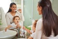 Dental, teeth and health with a mother and baby brushing teeth in the bathroom of their home together. Children, oral Royalty Free Stock Photo