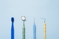 Dental tools and toothbrush on a blue background. Dental care concept Royalty Free Stock Photo