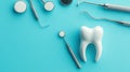 Dental Tools and White Tooth Model Arranged on a Light Blue Background Royalty Free Stock Photo