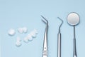 Dental tools and Zircon dentures on a blue background - Ceramic veneers - lumineers