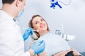 Dental treatment in dental office. Attractive woman with a beautiful smile at the dentist appointment. Professional doctor dentist