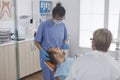 Dental woman nurse applying anesthesia with cotton swab