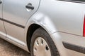 Dented car wing and fender with scratches and bumps after crash and car accident with hit-and-run driving and absconding shows nee Royalty Free Stock Photo