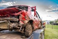 Dented and damaged rear end of a modified car used for a demolition derby loaded on a trailer Royalty Free Stock Photo