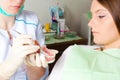 Dentis showing teeth prosthesis for woman patient Royalty Free Stock Photo