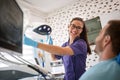 Dentist adjusting lamp in dental ordination Royalty Free Stock Photo