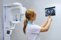 Dentist analyzes a dental panoramic x-ray film