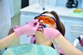 Dentist applies whitening gel to patient teeth