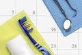 Dentist appointment in calendar dental care concept reminder in month calendar toothbrush dental tools and toothpaste flat lay Royalty Free Stock Photo