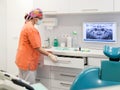 Dentist assistant preparing instruments for dental treatment in dentist surgery