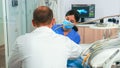 Dentist and assistant work with a patient in modern dental clinic Royalty Free Stock Photo