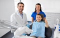 Dentist and boy showing thumbs up at dental clinic Royalty Free Stock Photo
