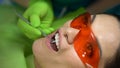 Dentist carefully placing sealant on central incisor, treating of chipped tooth