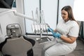 The dentist carefully prepares to receive patients in front of the dental chair in the medical center. In a dental