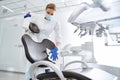 Dentist carefully sterilize the medical armchair inside a dental clinic Royalty Free Stock Photo