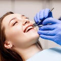Dentist check-up teeth to young woman patient in clinic.