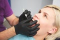 Dentist checking bracket at the braces on the female patient. Close-up. Real People. Royalty Free Stock Photo