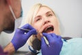 Dentist checking bracket at the braces on the female patient. Close-up. Real People. Royalty Free Stock Photo