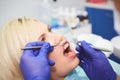 Dentist checking bracket at the braces on the female patient. Close-up. Real People. Royalty Free Stock Photo