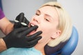 Dentist checking bracket at the braces on the female patient. Close-up. Real People. Royalty Free Stock Photo