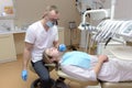 Dentist checking the teeth of a young patient Royalty Free Stock Photo