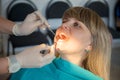 Dentist checking a woman for cavities. Royalty Free Stock Photo