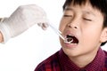 Dentist checking young asian boy teeth