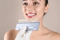 Dentist checking young woman`s teeth color Royalty Free Stock Photo