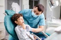 Dentist checks the child`s teeth