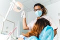 Dentist checks a young patient in the dental office - Health and wellness concept