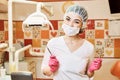 Children`s doctor dentist girl in the dental office holding a tool Royalty Free Stock Photo