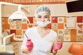 Children`s doctor dentist girl in the dental office holding a tool Royalty Free Stock Photo