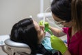 Dentist cleaning teeth of woman