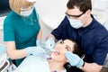 Dentist cleaning a woman teeth