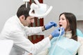 Dentist cleans the patient teeth with ultrasound