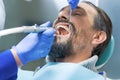 Dentist cleans teeth.