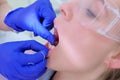 Dentist cleans woman patient`s teeth use dental floss in dentistry closeup view.