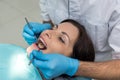 Dentist comparing patient`s teeth color with sampler Royalty Free Stock Photo