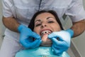 Dentist comparing patient teeth with crown sampler Royalty Free Stock Photo