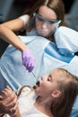 Dentist curing a child patient in the dental office
