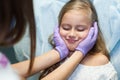 Dentist curing a child patient in the dental office