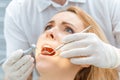 Dentist curing scared patient looking up Royalty Free Stock Photo