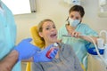 Dentist curing woman patient in dental office