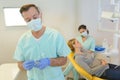 Dentist curing woman patient in dental office