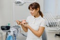 Dentist demonstrate mock-up of human jaws and explain caries prevention and treatment. Close-up of teeth model in doctor