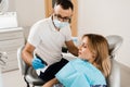 Dentist demonstrate teeth color shades guide for tooth whitening for woman patient in dental clinic. Dentistry. Woman Royalty Free Stock Photo