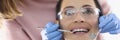 Dentist doctor examines oral cavity of woman in office