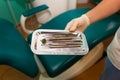Dentist doctor holds many dental instruments in his hands. Sterile dental instruments close-up