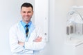 Dentist Doctor Portrait. Young Man at His Workplace. Dental Clin